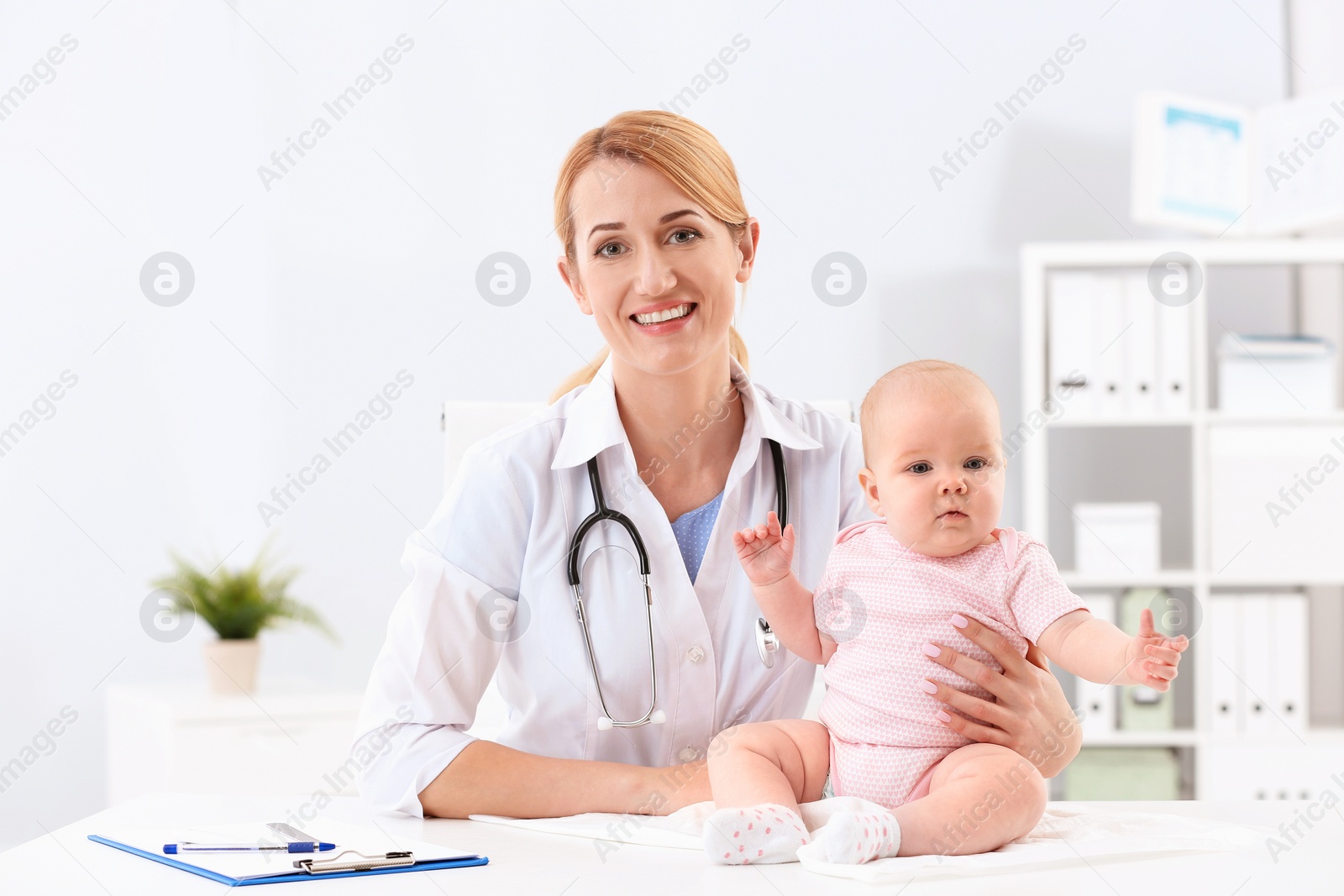 Photo of Children's doctor with cute baby in hospital