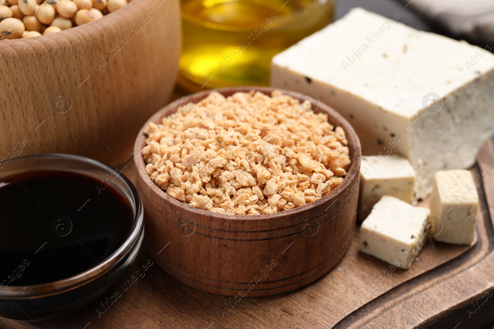 Photo of Different organic soy products on wooden board, closeup