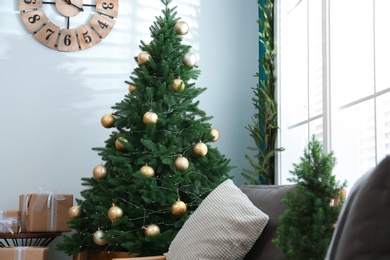 Photo of Beautiful decorated Christmas tree in living room