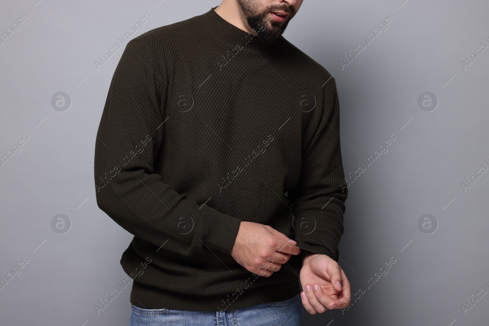 Photo of Man in stylish sweater on grey background, closeup