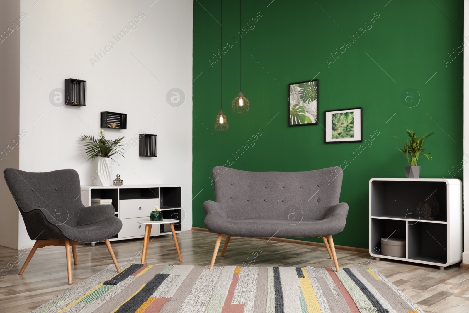 Photo of Modern living room interior stylish sofa near green wall