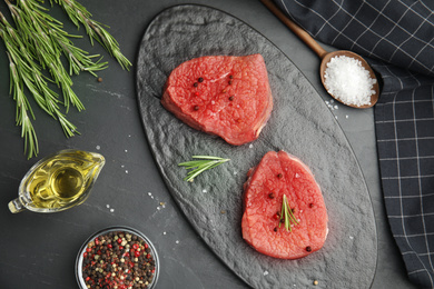 Flat lay composition with fresh beef cut on black table