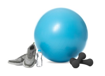 Photo of Fitness ball, sneakers, bottle of water and dumbbells isolated on white