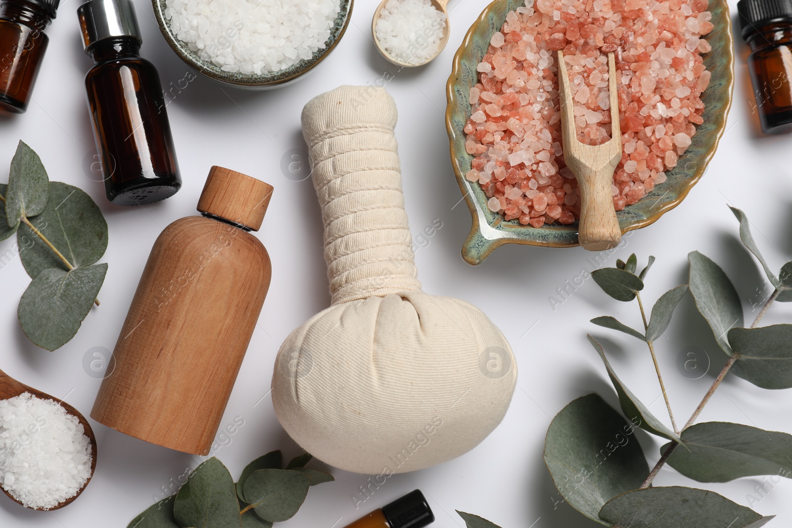 Photo of Different aromatherapy products and eucalyptus leaves on white background, flat lay