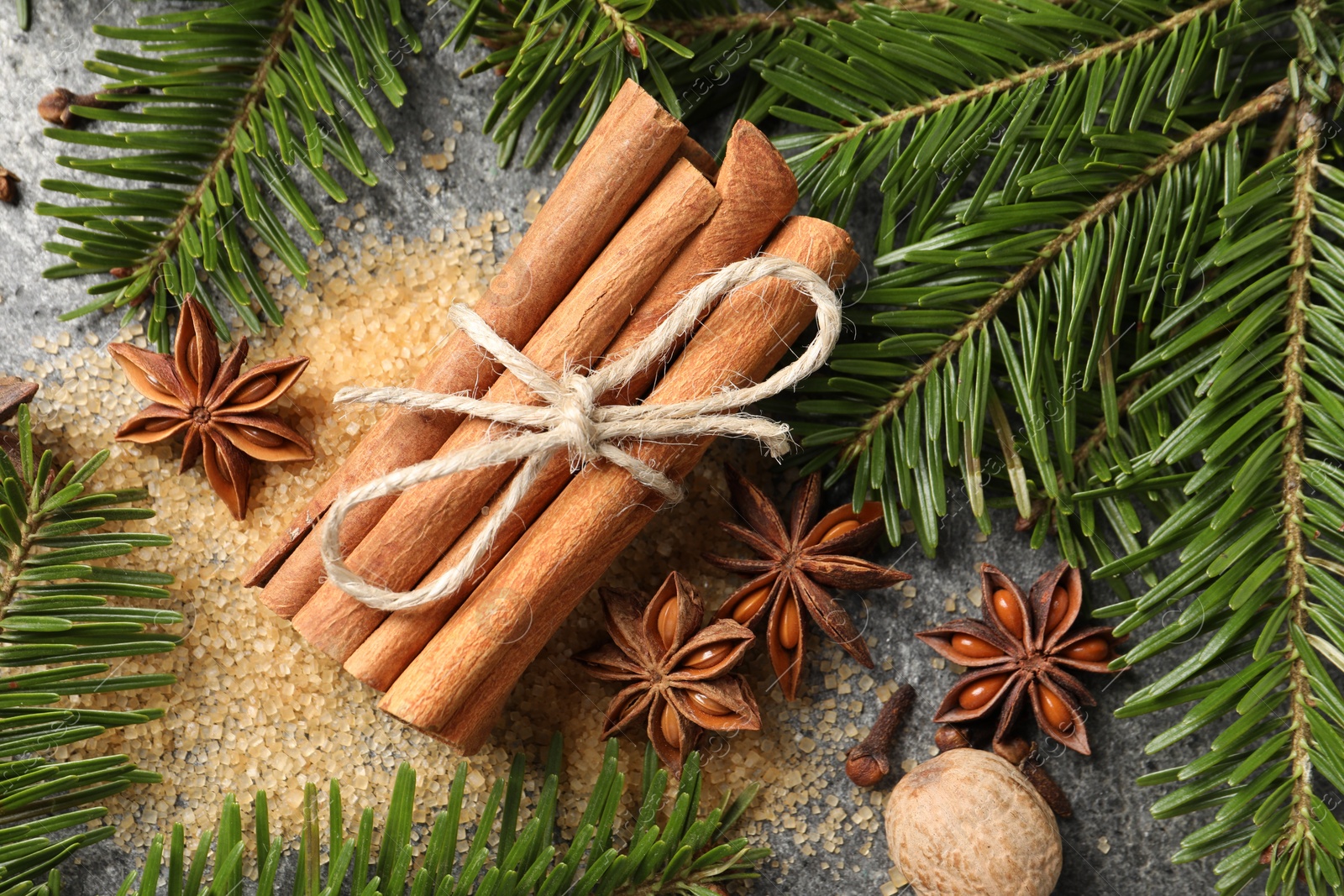 Photo of Different spices and fir branches on table, flat lay