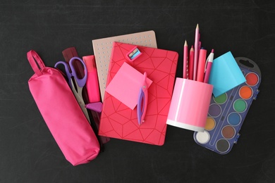 Photo of Flat lay composition with different school stationery on blackboard. Back to school