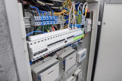 Photo of Panel with electric meters and many wires in fuse box