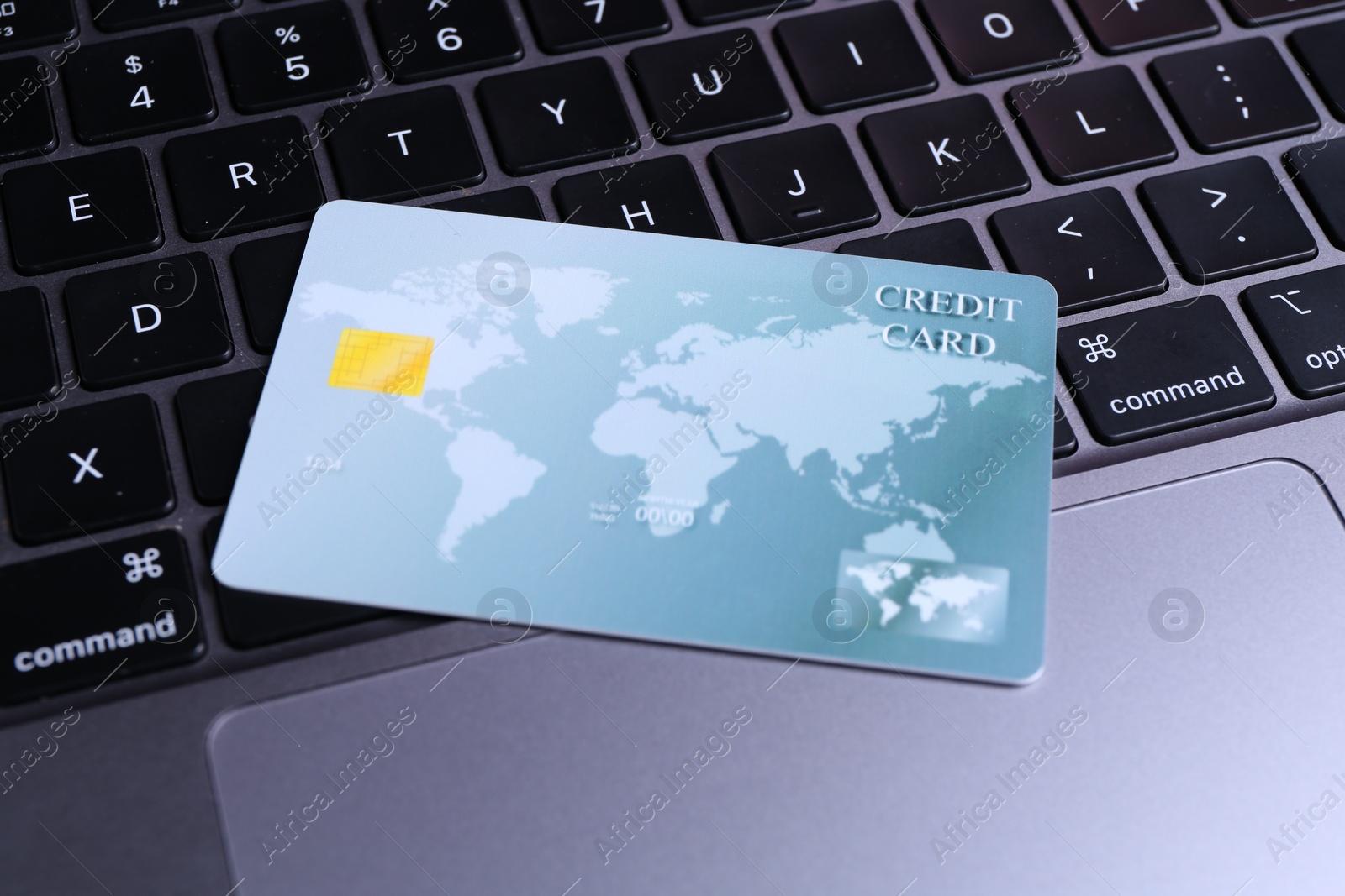 Photo of One plastic credit card on modern laptop