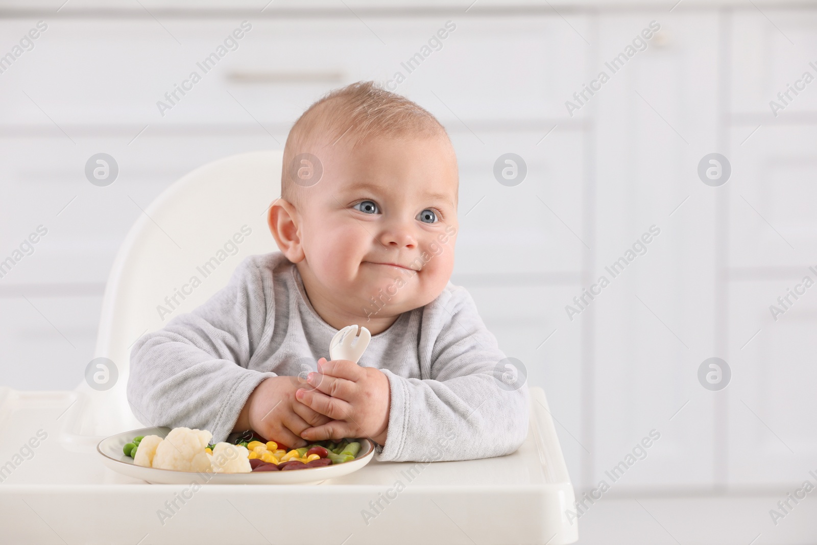 Photo of Cute little baby eating healthy food at home. Space for text