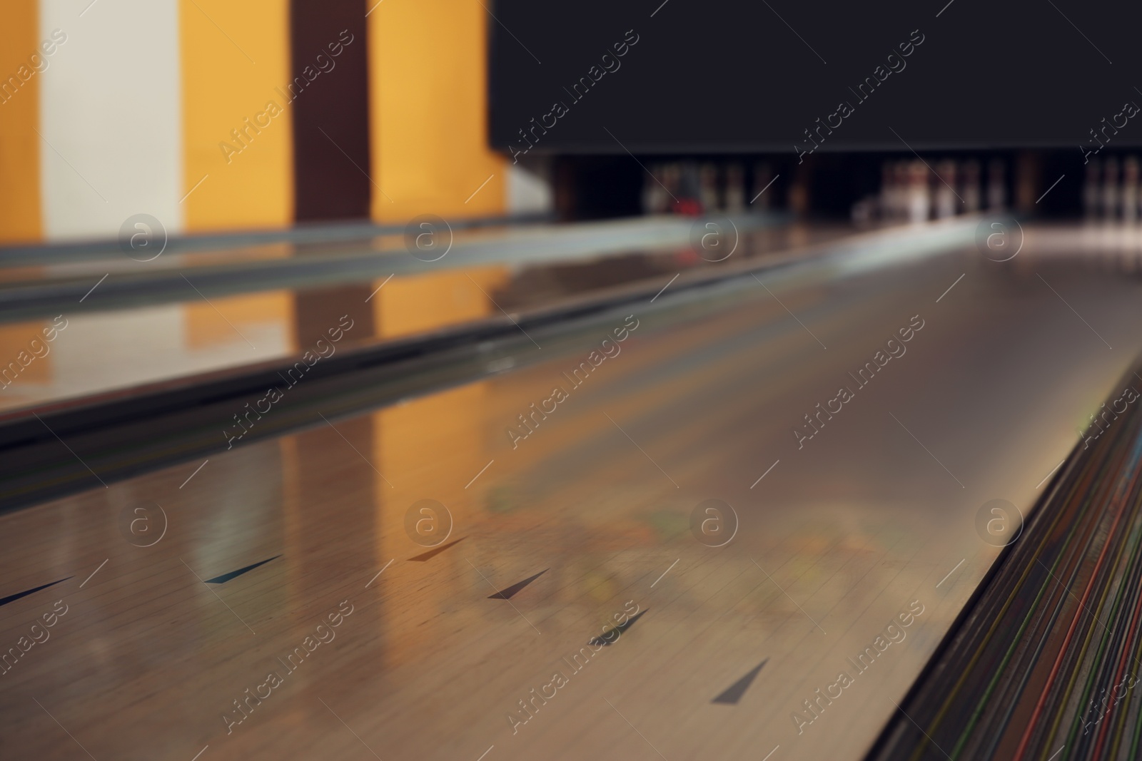 Photo of Empty wooden alley in modern bowling club