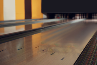 Empty wooden alley in modern bowling club