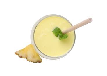 Photo of Tasty pineapple smoothie in glass and slice of fruit isolated on white, top view