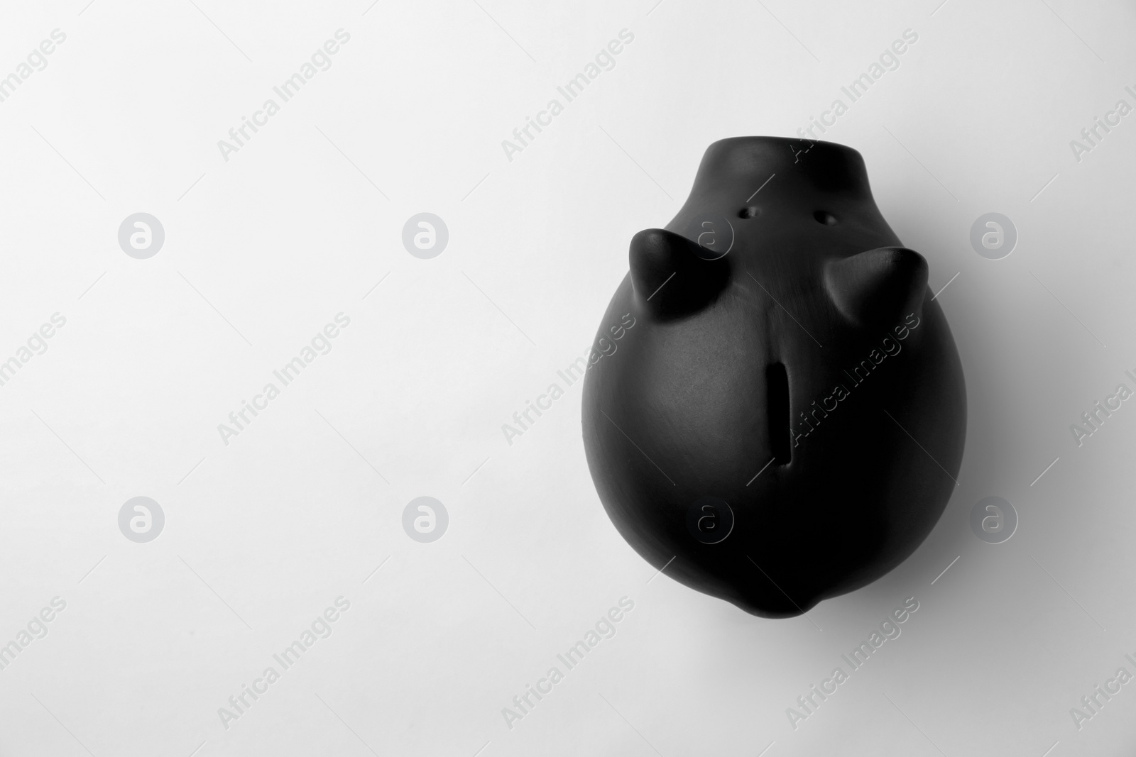 Photo of Black piggy bank on white background, top view