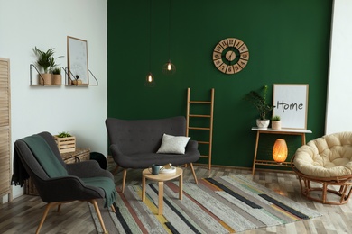 Modern living room interior stylish sofa near green wall