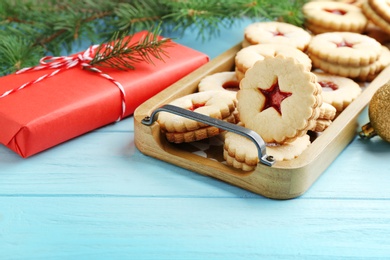Photo of Traditional Christmas Linzer cookies with sweet jam on wooden tray