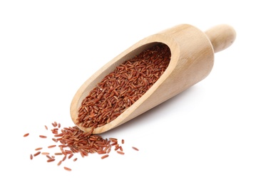 Scoop with uncooked red rice on white background