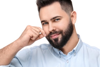 Photo of Happy young man touching mustache on white background