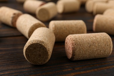 Photo of Many corks of wine bottles on wooden table, closeup