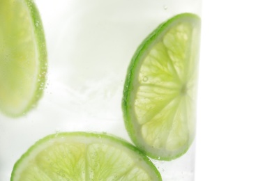 Drink with lime and ice cubes isolated on white, closeup