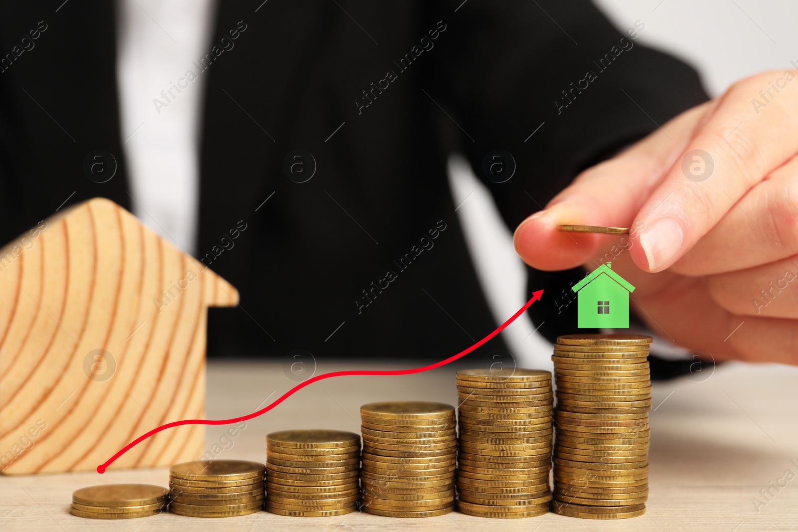 Image of Mortgage rate. Woman stacking coins on table, closeup. Arrow and model of house