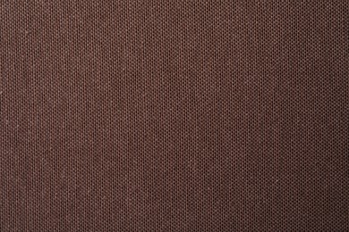 Photo of Texture of brown fabric as background, top view