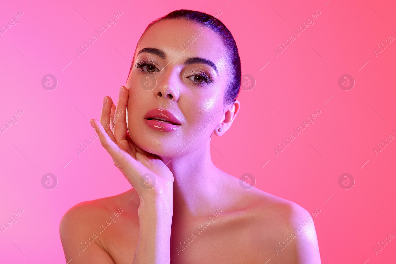 Photo of Beautiful young woman posing on pink background