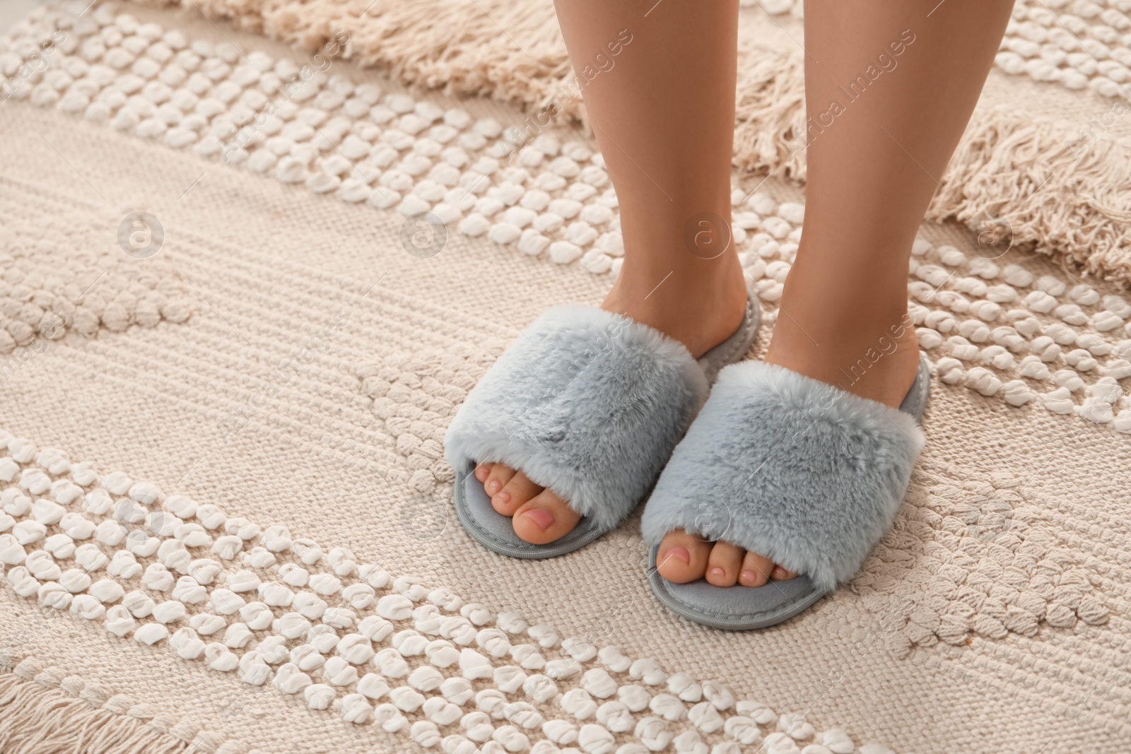 Photo of Woman wearing soft slippers at home, closeup