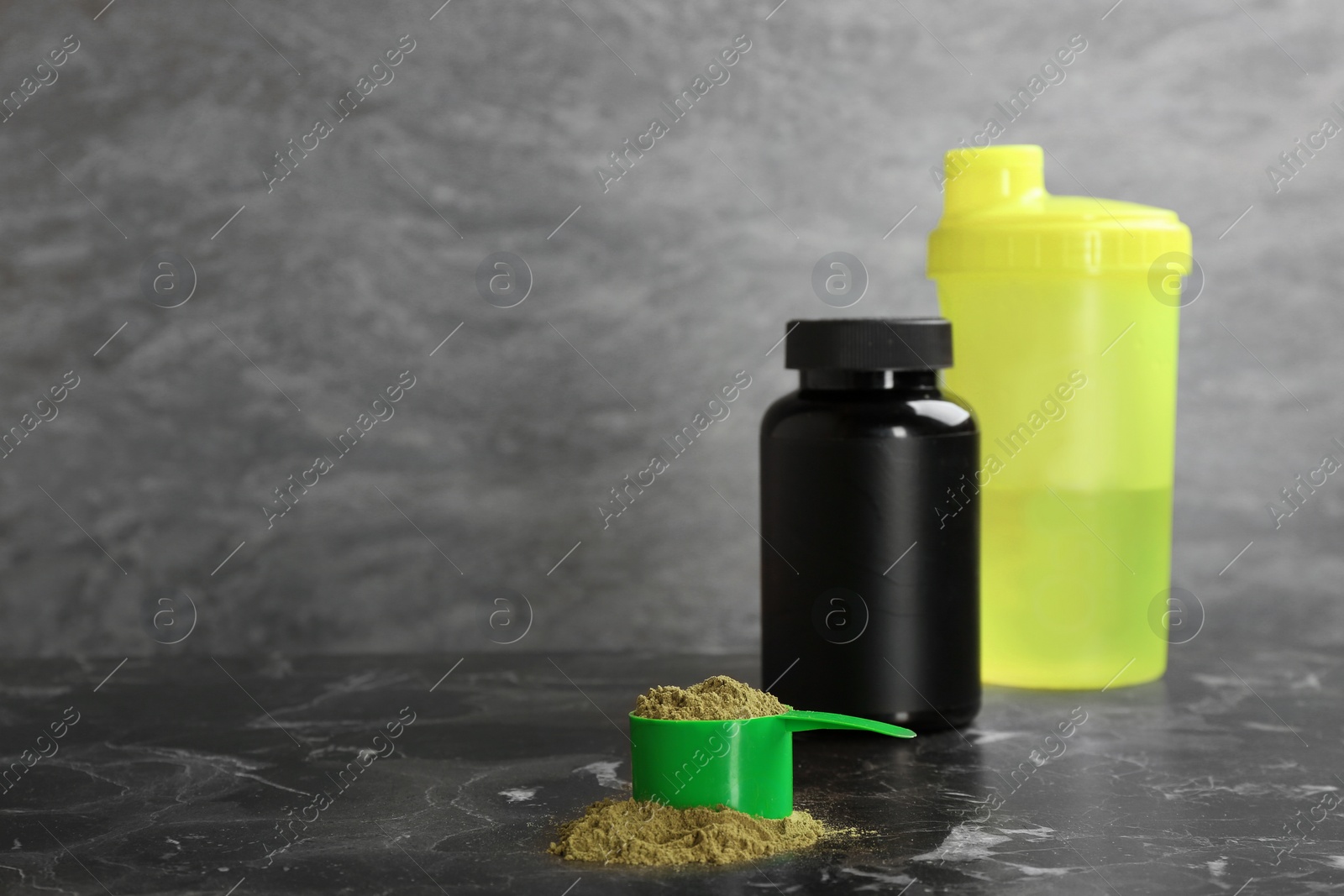 Photo of Hemp protein powder in measuring spoon, jar and shaker on table. Space for text