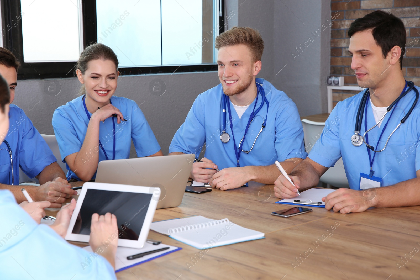 Photo of Medical students in uniforms studying at university