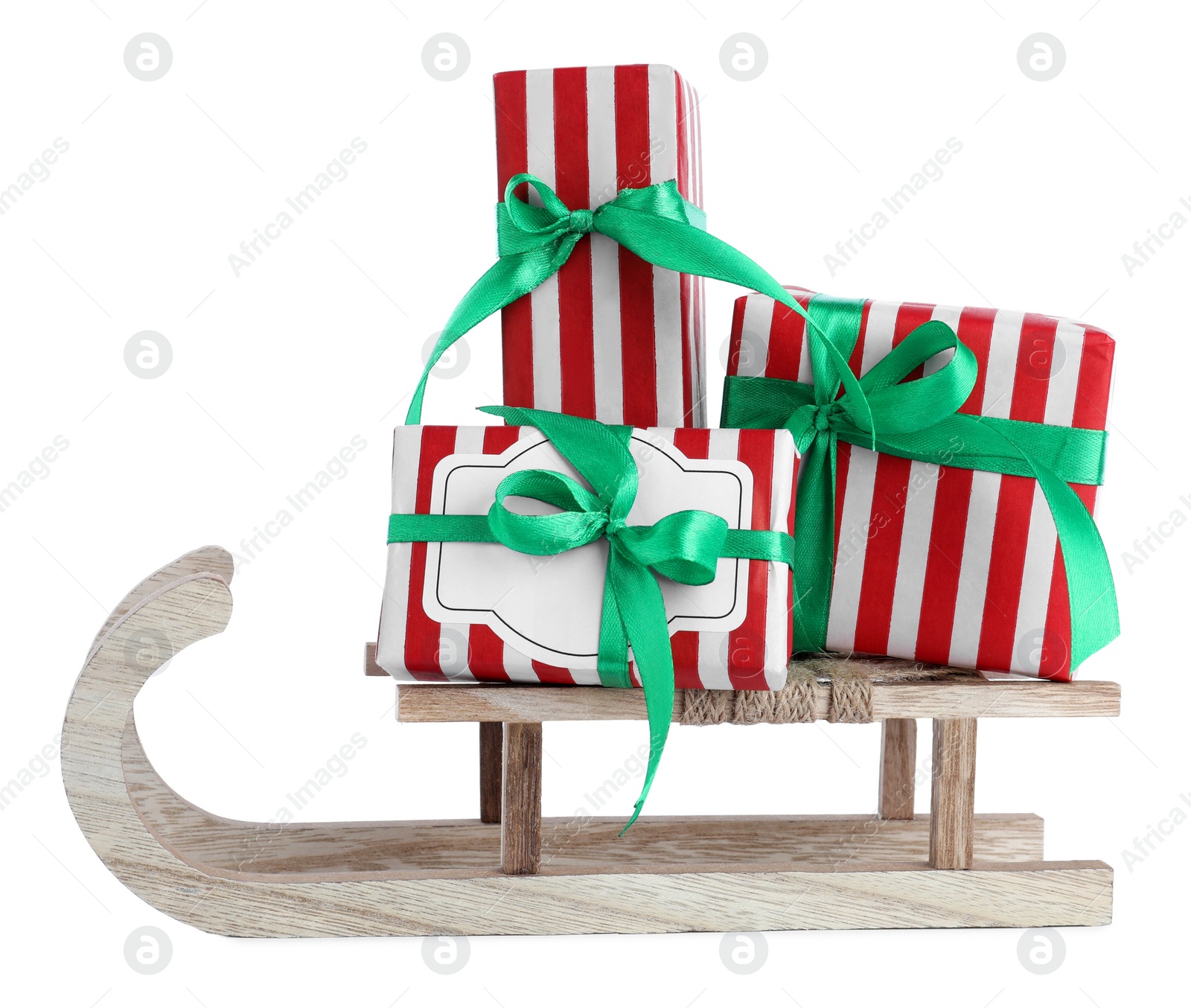 Photo of Wooden sleigh with gift boxes isolated on white. Christmas holiday decor