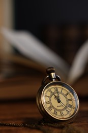 Pocket clock with chain on table, closeup