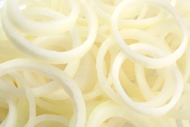 Photo of Fresh ripe onion rings as background, top view