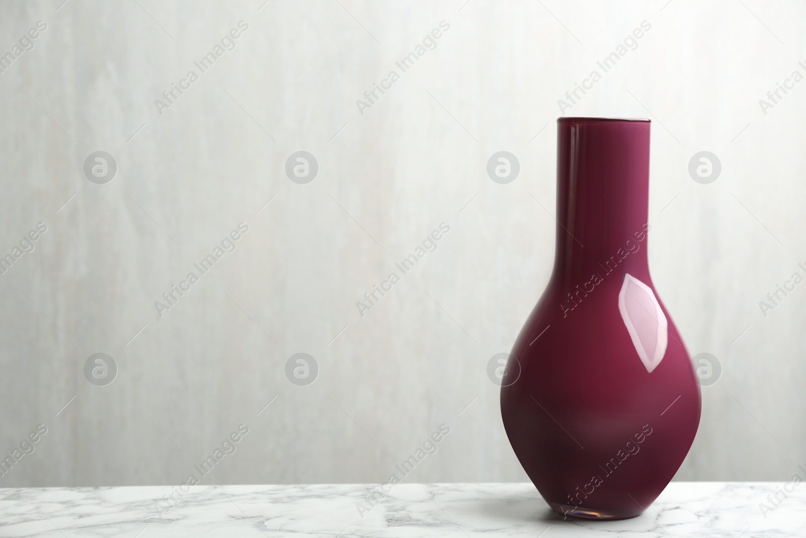 Photo of Stylish empty ceramic vase on white marble table, space for text