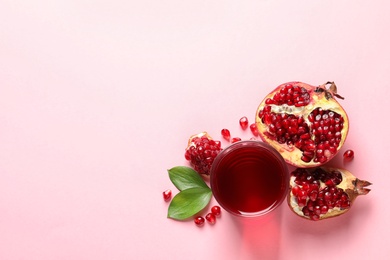 Photo of Glass of pomegranate juice and fresh fruits on color background, top view with space for text