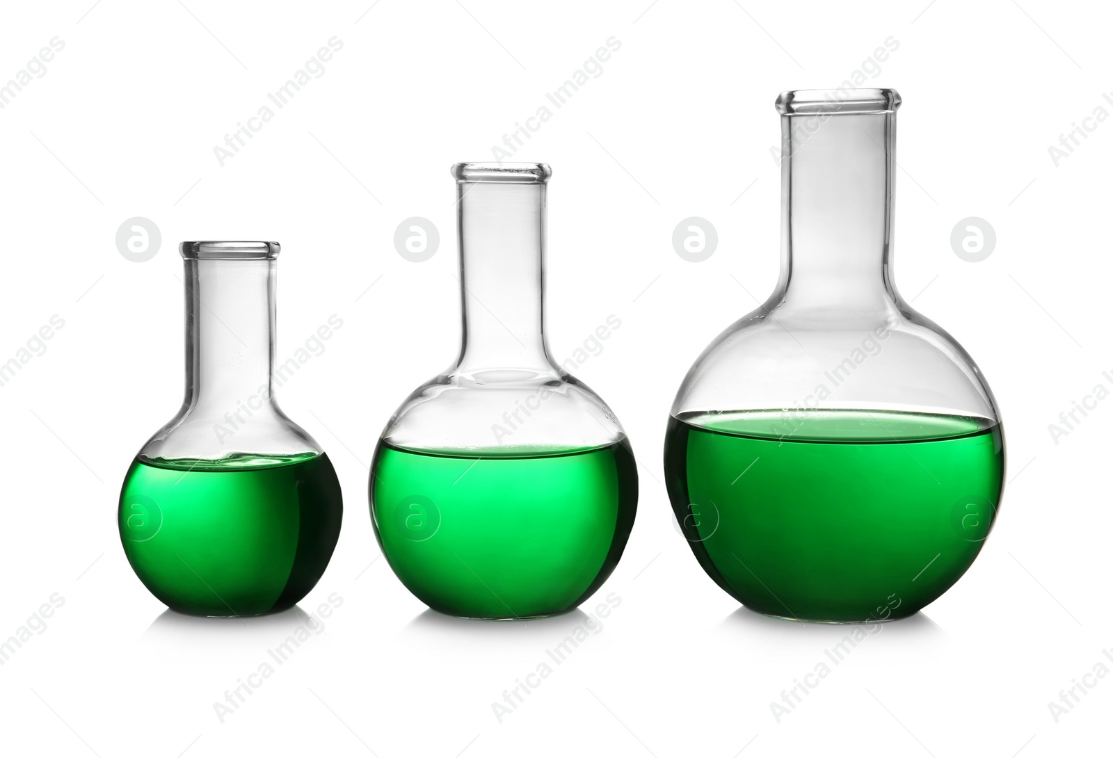 Photo of Florence flasks with green liquid on white background