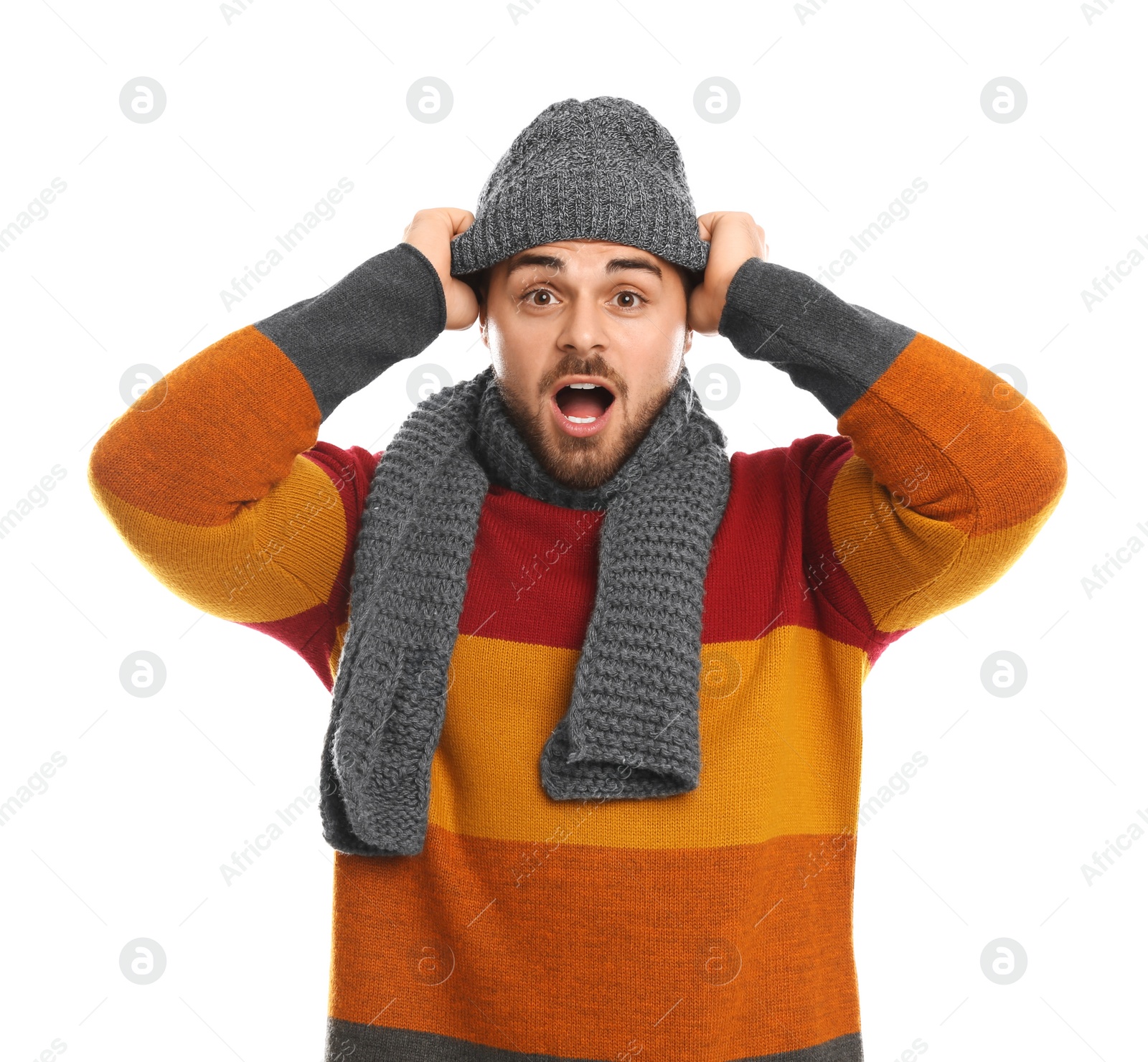 Photo of Emotional young man in warm clothes on white background. Winter vacation