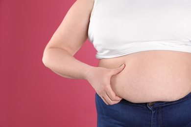 Overweight woman on color background, closeup. Space for text