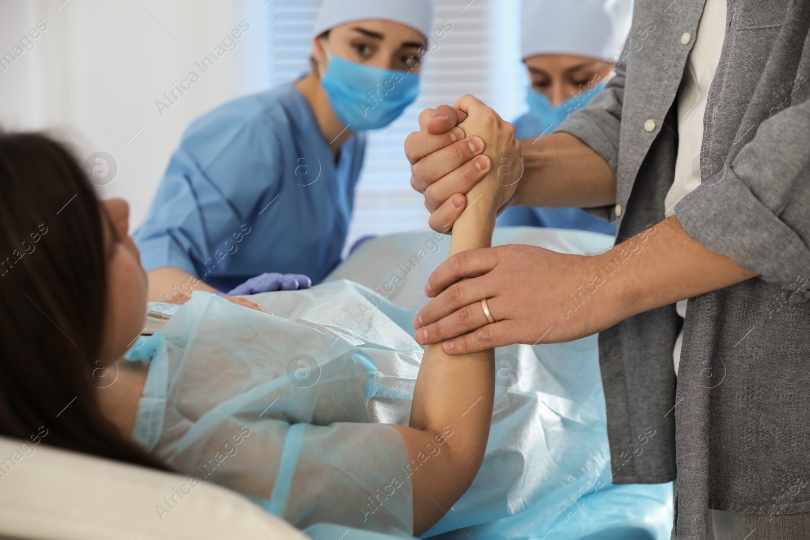 Photo of Woman giving child birth in maternity hospital, closeup