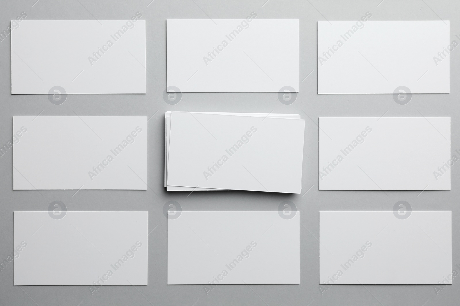 Photo of Blank business cards on light gray background, flat lay. Mockup for design