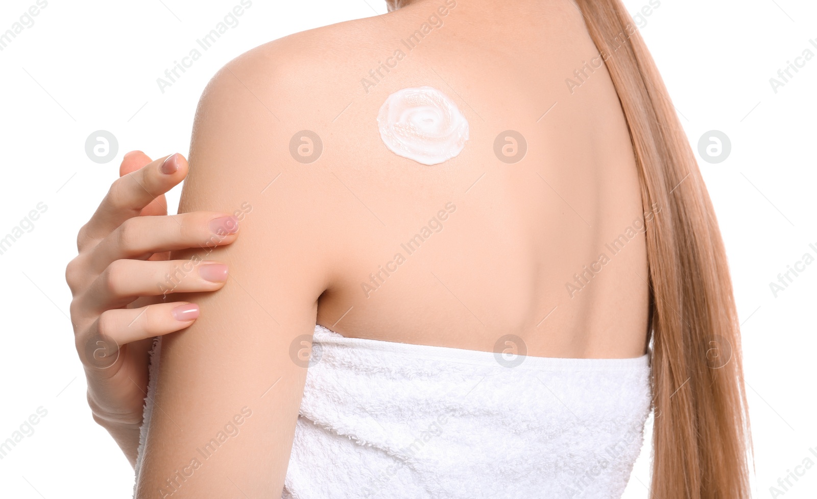 Photo of Young woman applying body cream on white background