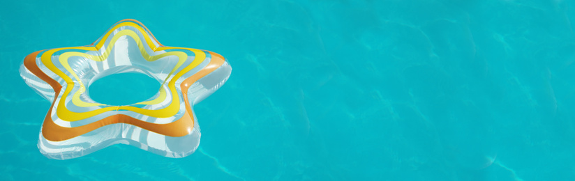 Image of Star shaped inflatable ring floating in swimming pool on sunny day, space for text. Banner design