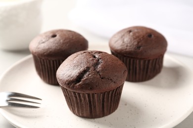Photo of Delicious fresh chocolate cupcakes on plate, closeup