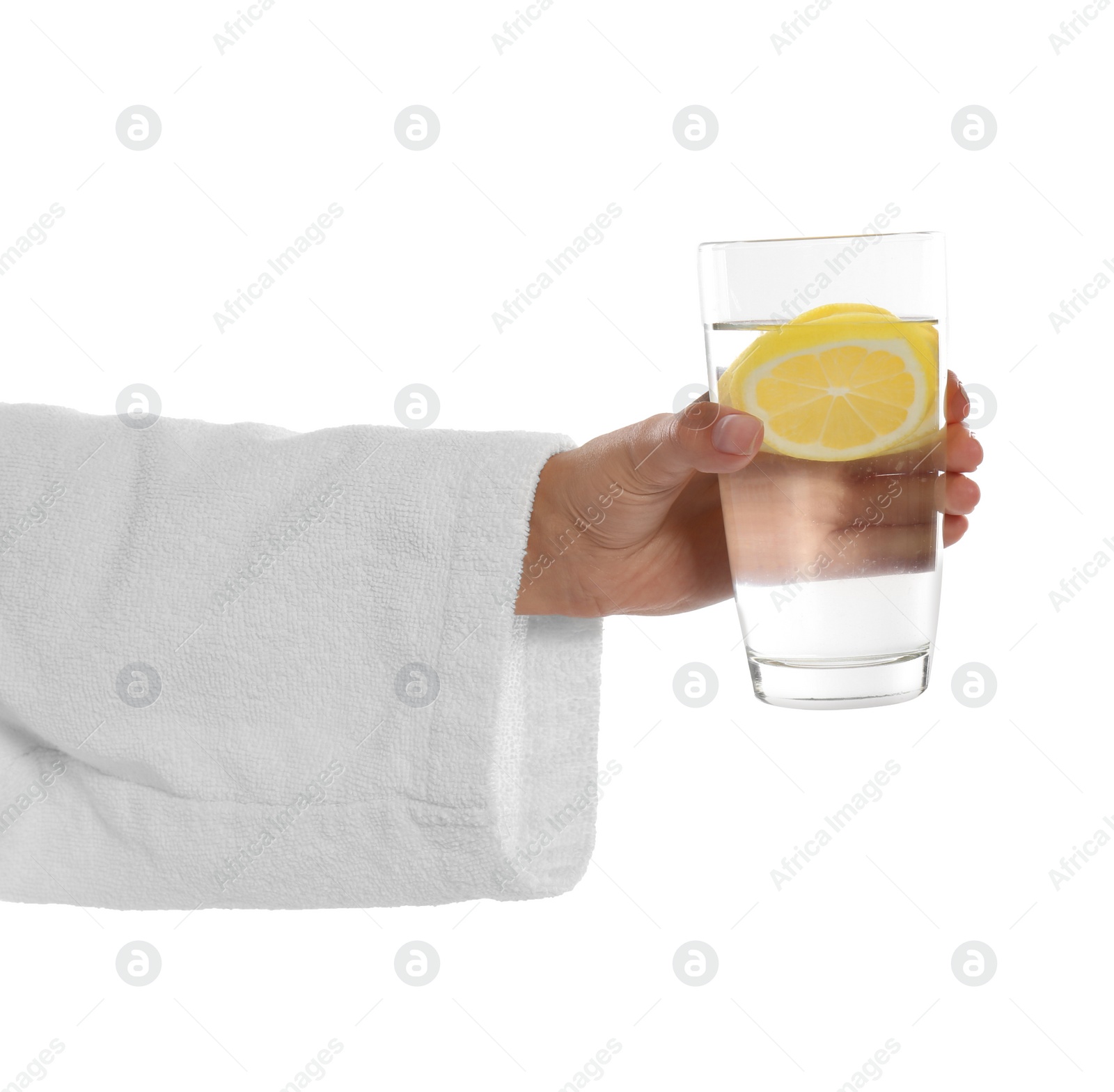 Photo of Young woman holding glass of lemon water on white background, closeup