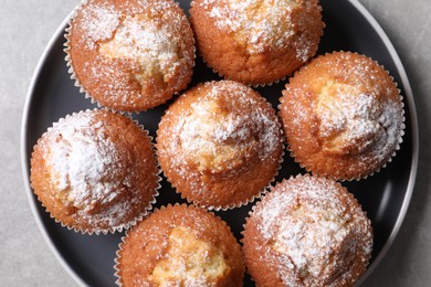 Photo of Delicious sweet muffins on light grey table, top view