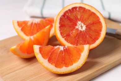 Slices of red orange on wooden board, closeup