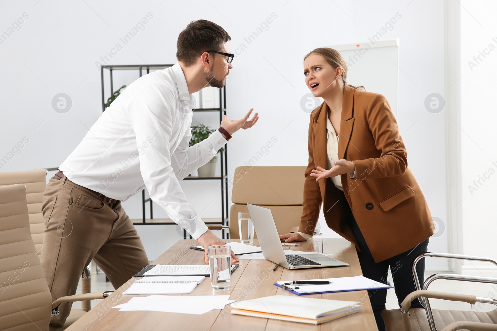 Photo of Emotional colleagues arguing in office. Toxic work environment
