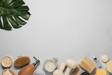 Bath accessories. Flat lay composition with personal care products on light grey background, space for text