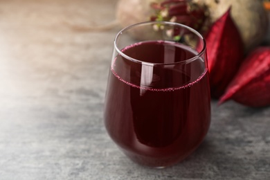 Photo of Glass with fresh healthy beet juice on table