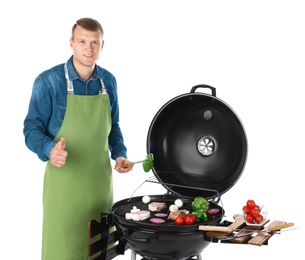 Photo of Man in apron cooking on barbecue grill, white background