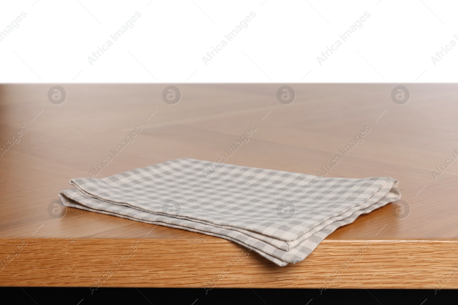 Photo of Checkered tablecloth on wooden table against white background